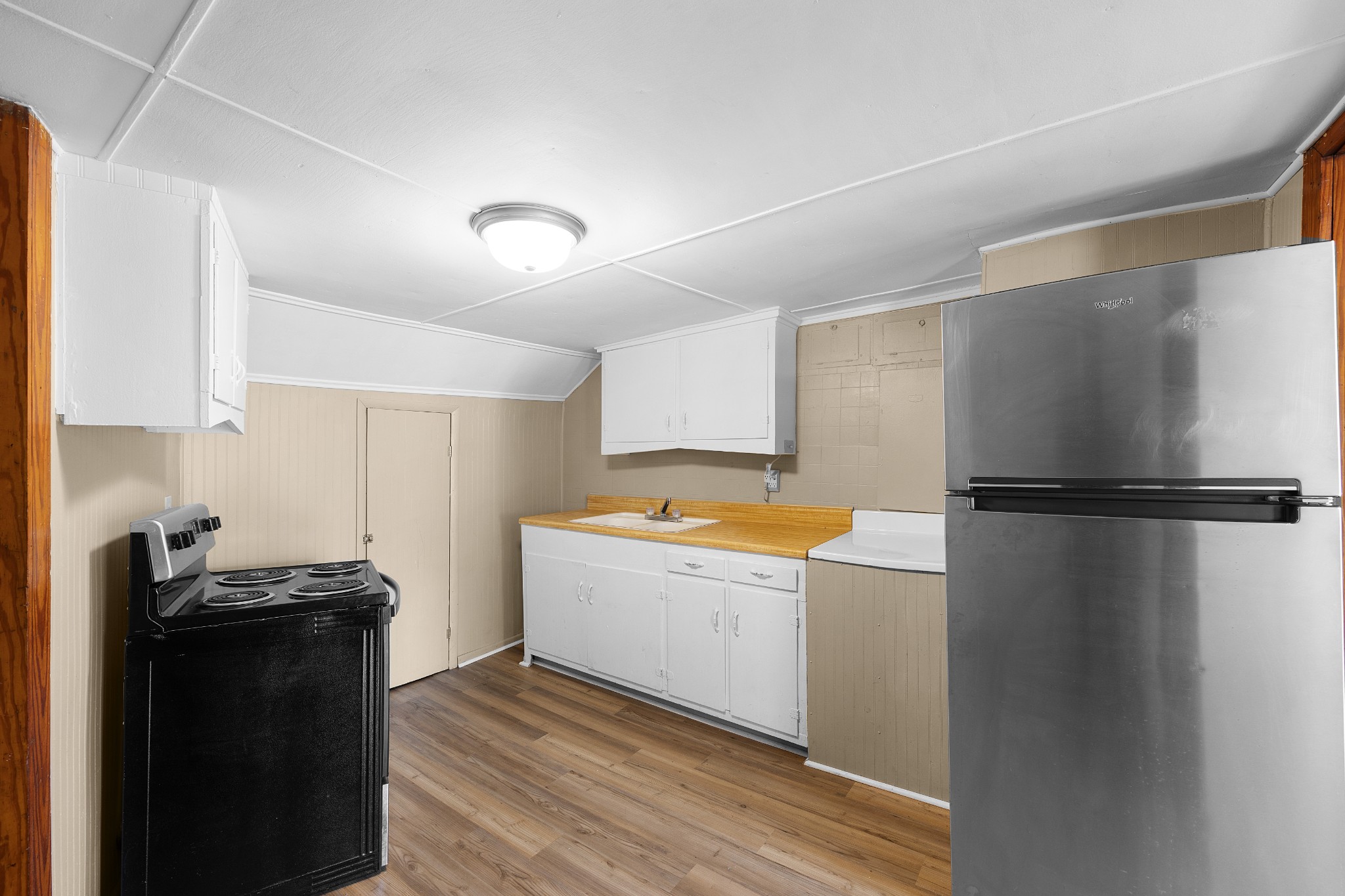 116 Summer Street Martin, TN 38237 - Photo 6 of 43 a kitchen with a refrigerator and a sink