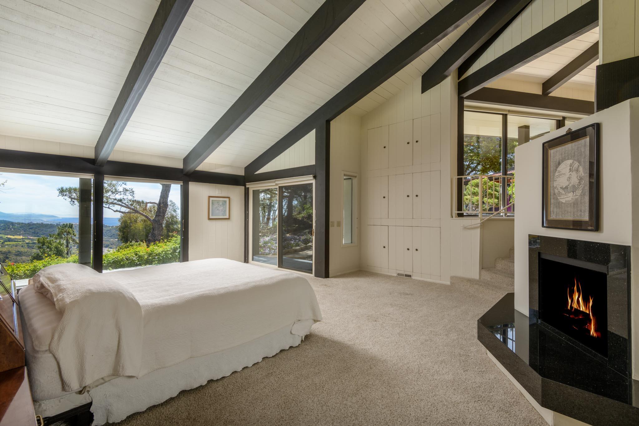 909 Park Lane Montecito, CA 93108 - Photo 32 of 39 a large bedroom with a large bed and a fireplace
