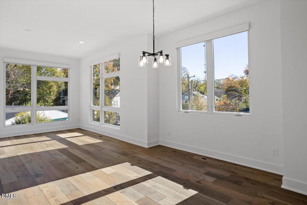603 North Queen Street Durham, NC 27701 - Photo 15 of 40 a view of an empty room with wooden floor and a window