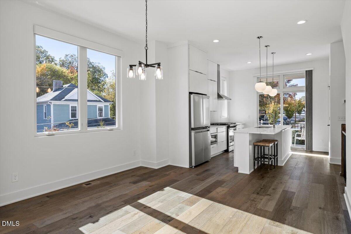 603 North Queen Street Durham, NC 27701 - Photo 16 of 40 a view of a livingroom with a fireplace wooden floor and windows