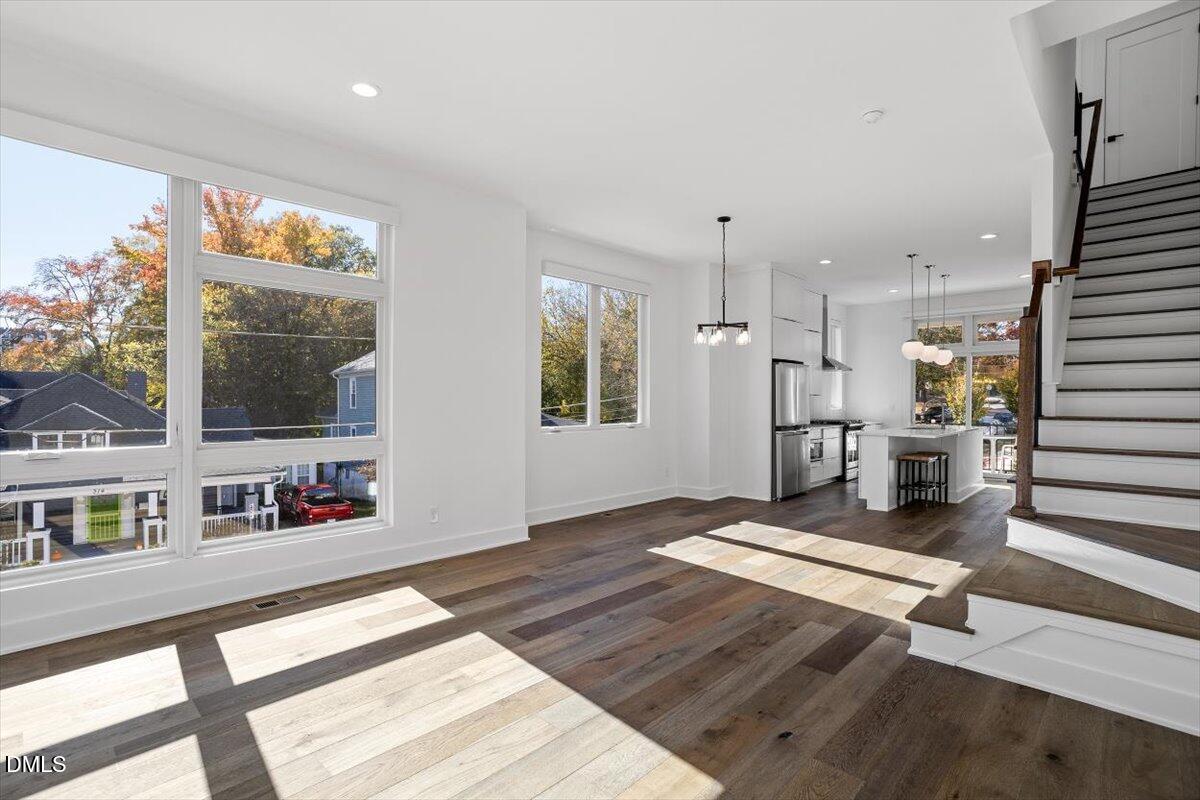 603 North Queen Street Durham, NC 27701 - Photo 22 of 40 a living room with kitchen view and a wooden floor