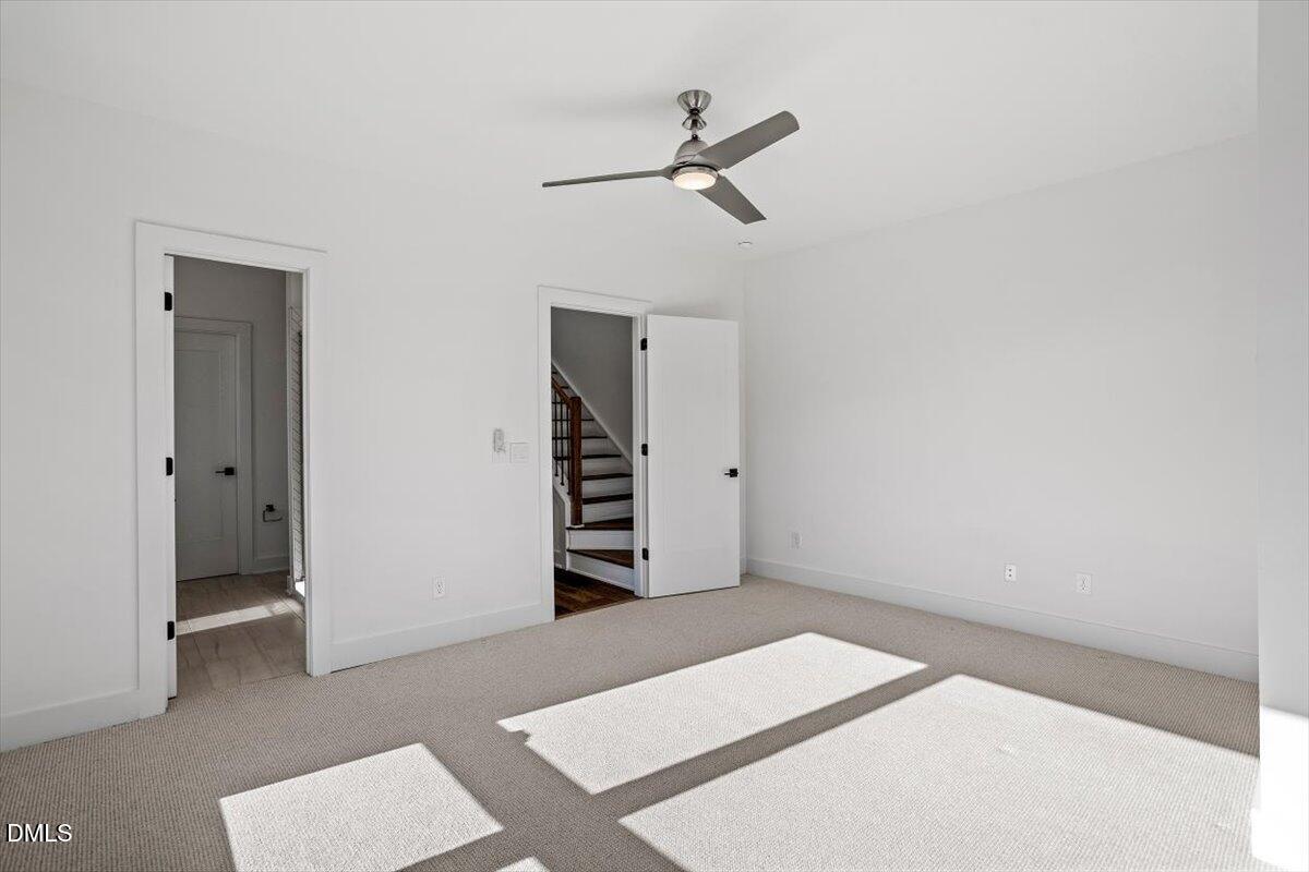 603 North Queen Street Durham, NC 27701 - Photo 27 of 40 a bedroom with a bed and a ceiling fan