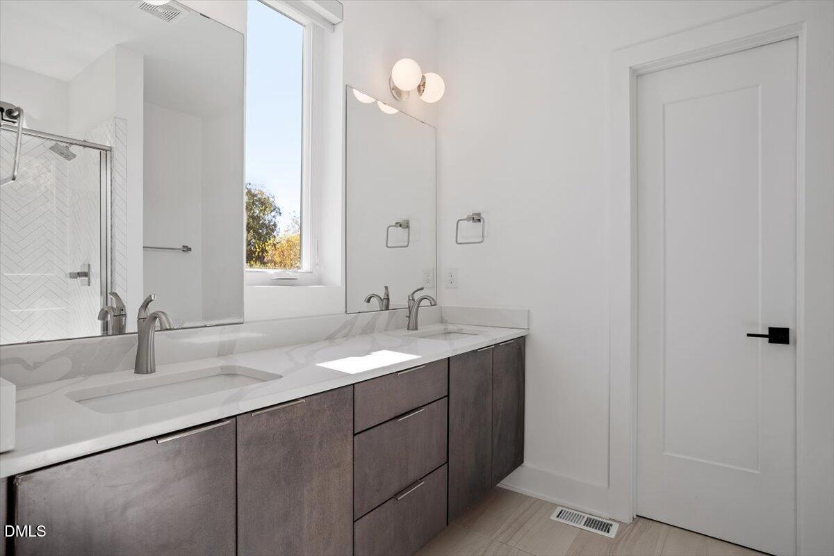603 North Queen Street Durham, NC 27701 - Photo 29 of 40 a bathroom with a sink and a mirror