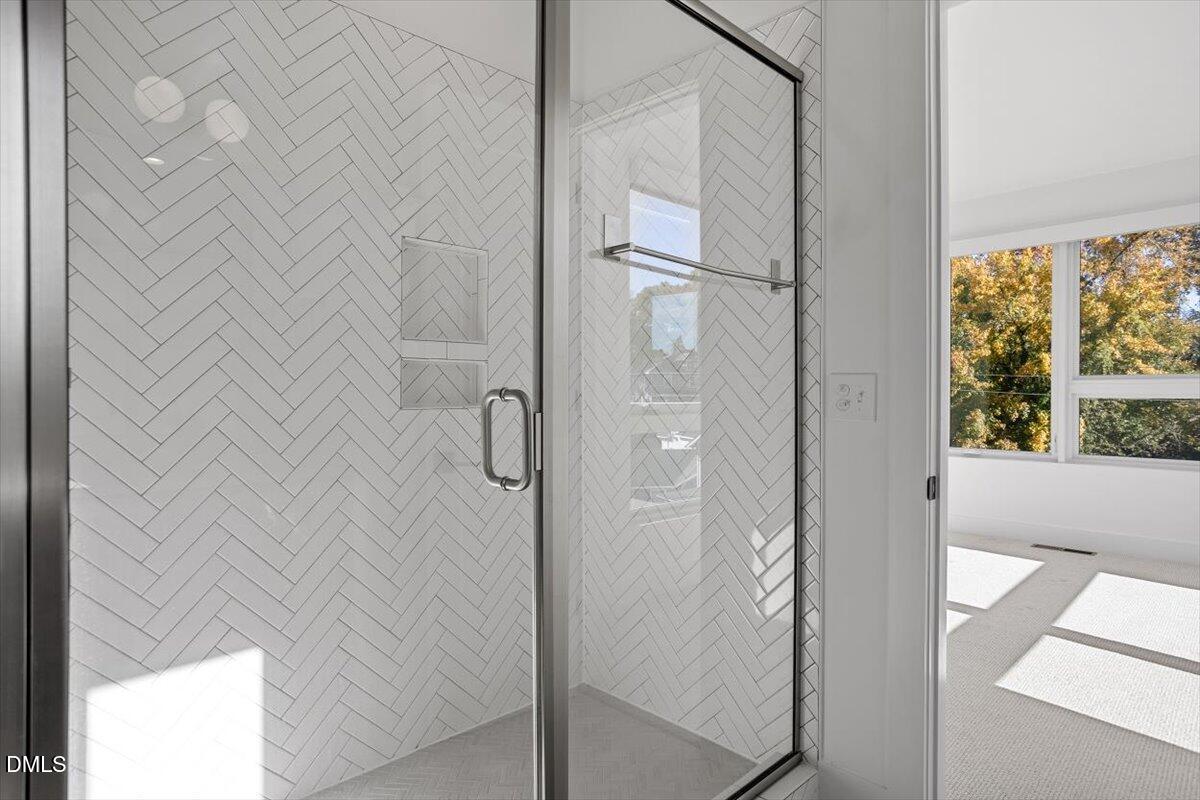 603 North Queen Street Durham, NC 27701 - Photo 30 of 40 a bathroom with a glass shower door