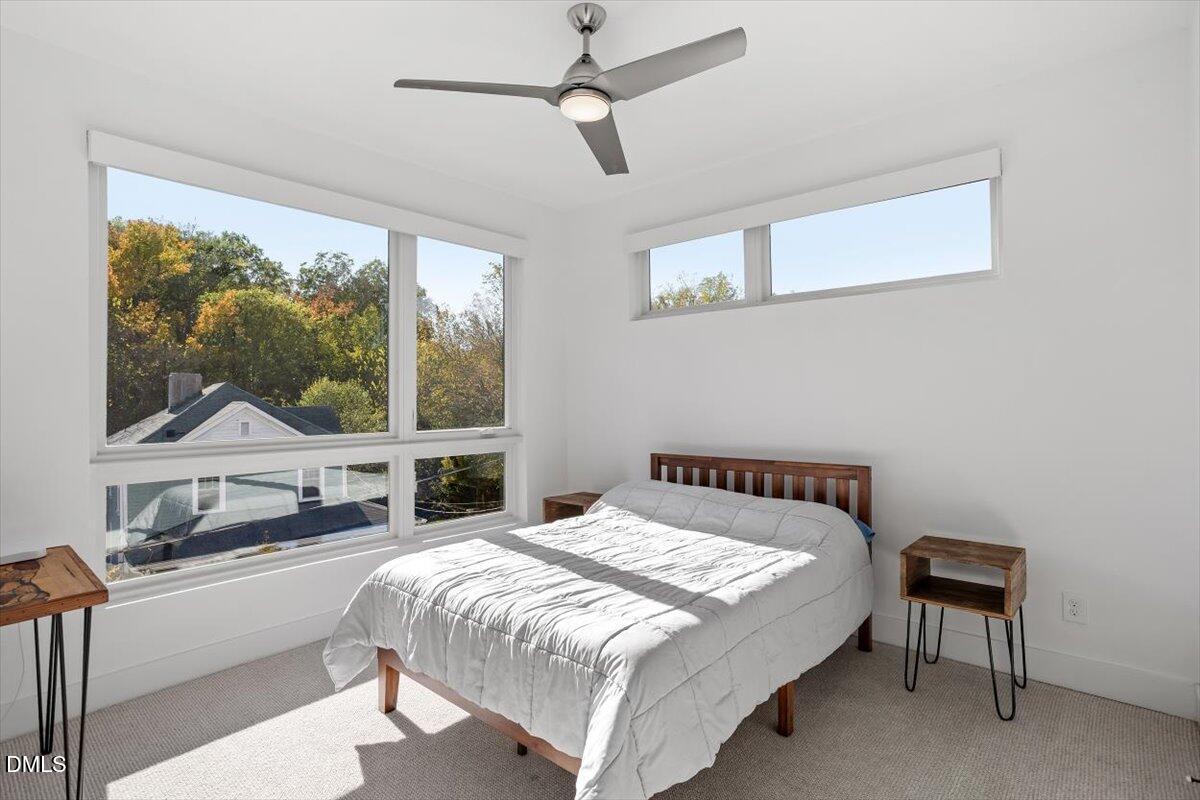 603 North Queen Street Durham, NC 27701 - Photo 32 of 40 a bedroom with a large bed and a window