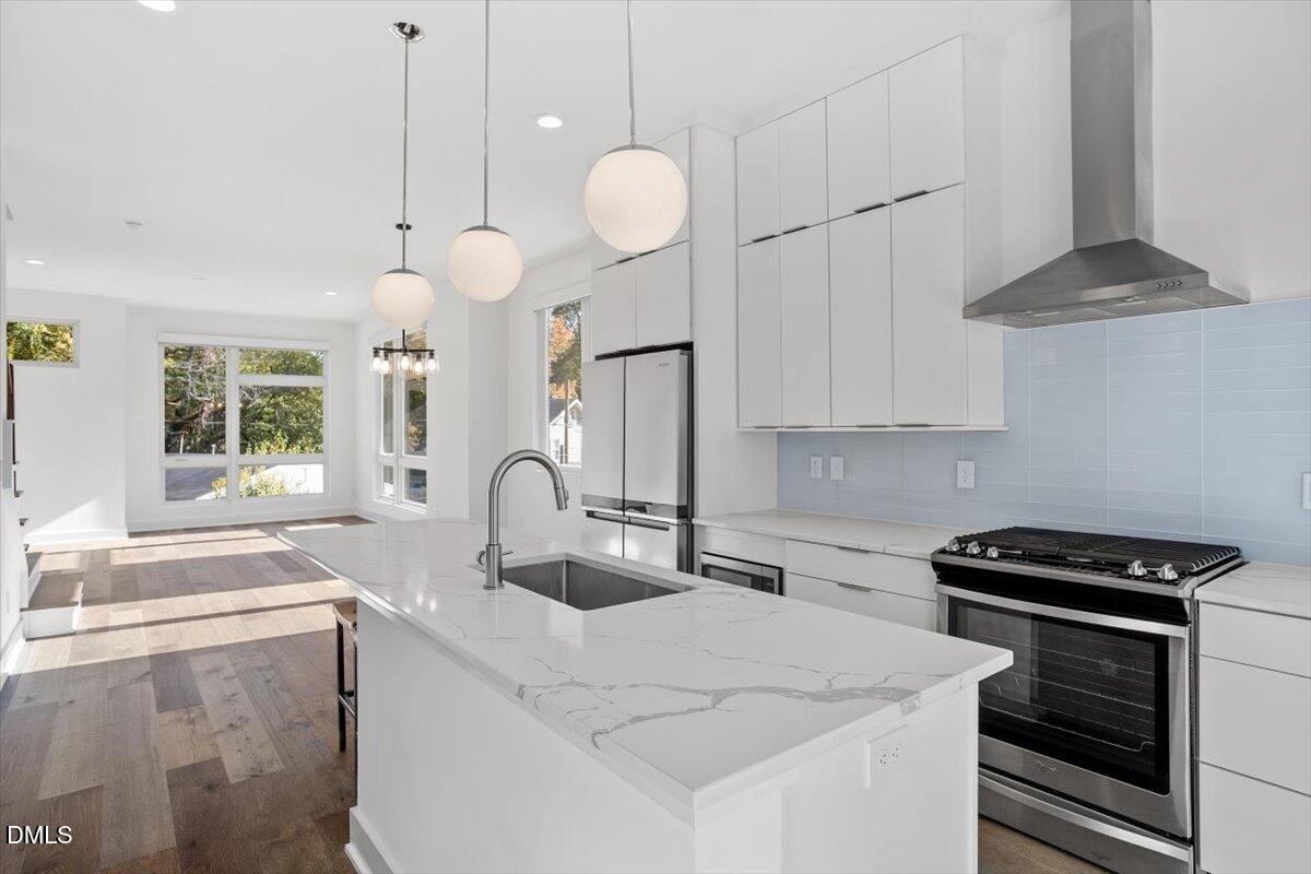 603 North Queen Street Durham, NC 27701 - Photo 9 of 40 a kitchen with granite countertop a sink a stove and cabinets