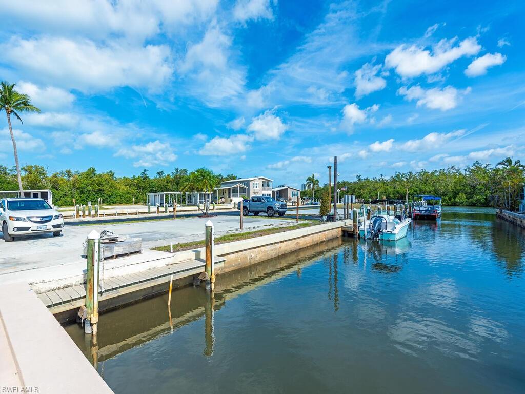 777 Walkerbilt Road, Unit 17 Naples, FL 34110 - Photo 12 of 19 a view of swimming pool with outdoor seating and plants