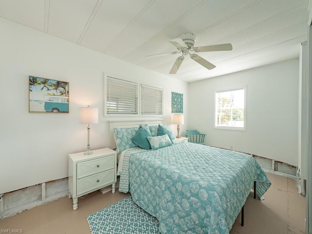 777 Walkerbilt Road, Unit 17 Naples, FL 34110 - Photo 8 of 19 a bedroom with a bed and a window