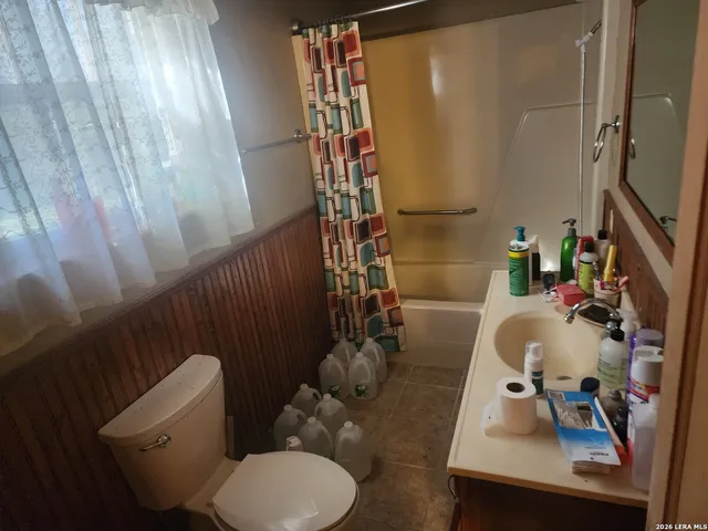 a bathroom with a sink toilet and shower