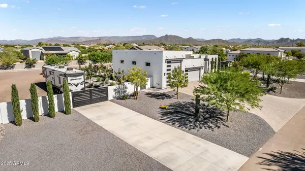 a large kitchen with stainless steel appliances kitchen island a large counter top a sink a stove a refrigerator and cabinets
