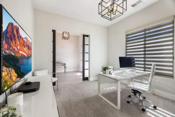 a bedroom with a bed and a television