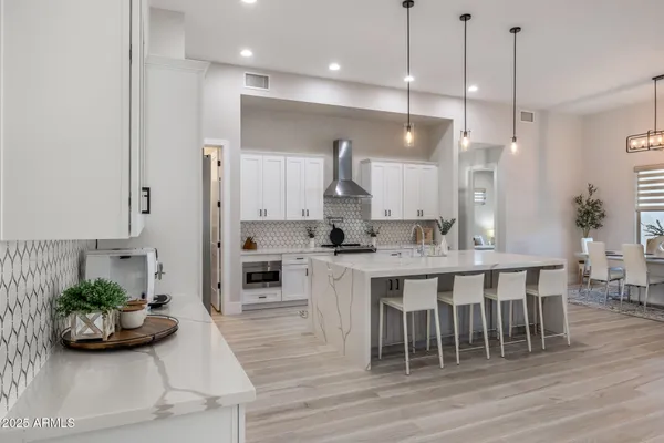 a kitchen with stainless steel appliances granite countertop a sink and a stove