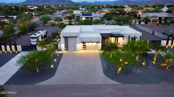 an aerial view of a house with a yard
