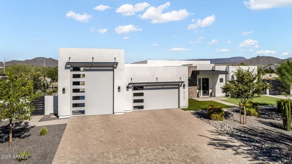 an aerial view of a house with outdoor space