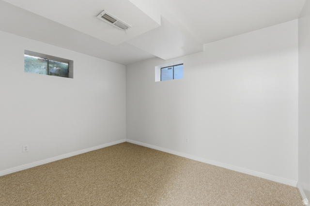 148 Tennyson Avenue Sandy, UT 84070 - Photo 37 of 55 Bright room featuring plush carpet flooring, white painted walls, white trim, and two elevated windows