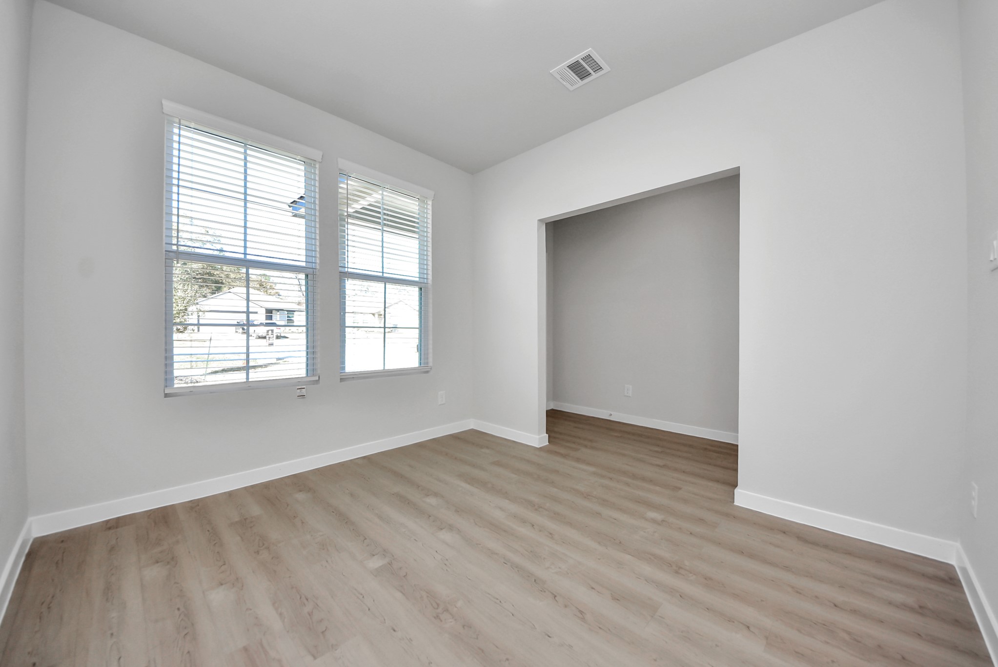 473 Shoreview Drive Conroe, TX 77303 - Photo 15 of 49 an empty room with wooden floor and windows