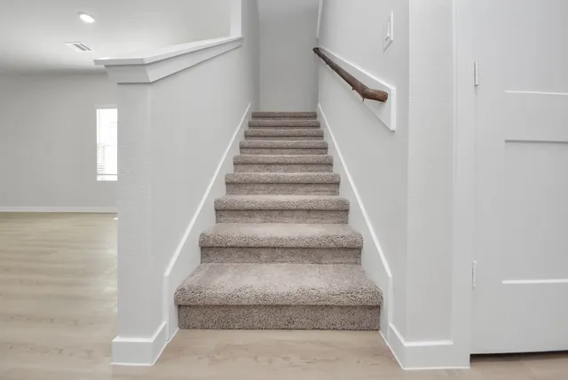 a view of staircase with white walls