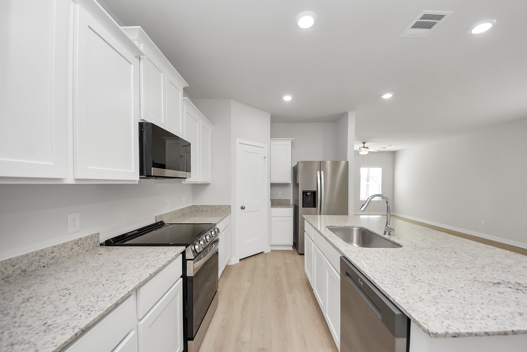 473 Shoreview Drive Conroe, TX 77303 - Photo 22 of 49 a kitchen with stainless steel appliances granite countertop a sink a stove and a refrigerator