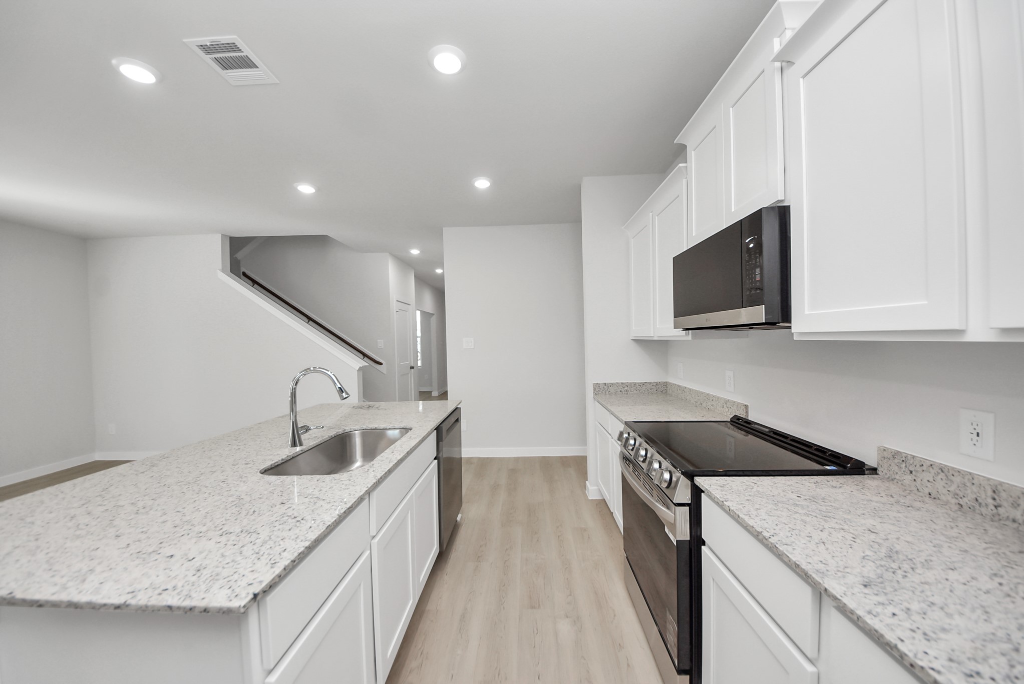 473 Shoreview Drive Conroe, TX 77303 - Photo 23 of 49 a kitchen with a sink stove and microwave