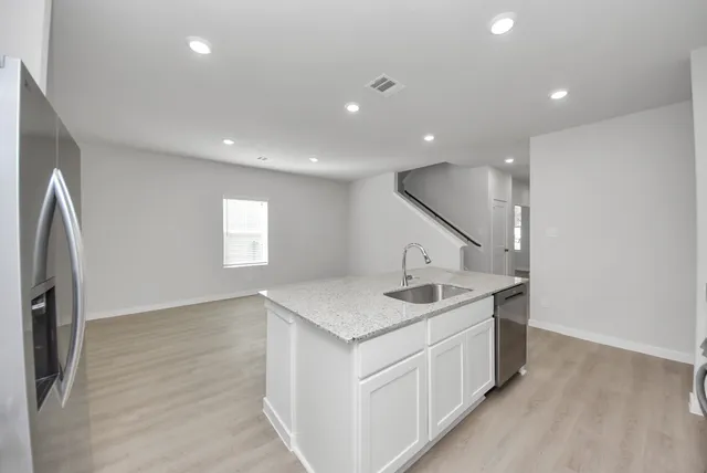a kitchen with a sink and a refrigerator