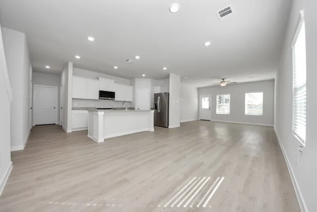 a view of a kitchen with a sink and dishwasher cabinets