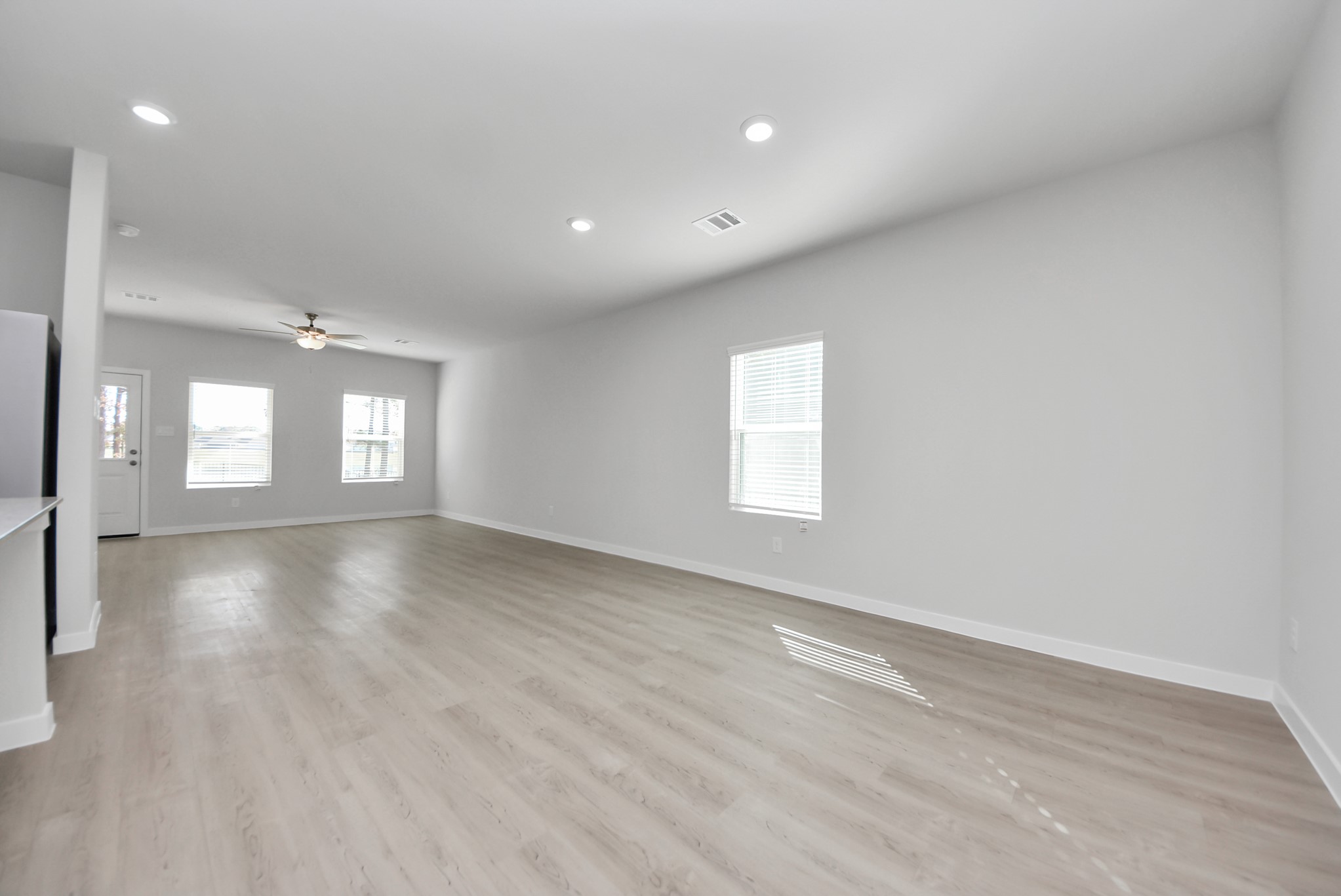 473 Shoreview Drive Conroe, TX 77303 - Photo 26 of 49 an empty room with wooden floor and windows