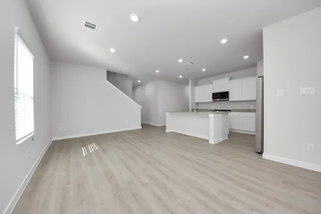 a view of kitchen with stove and wooden floor