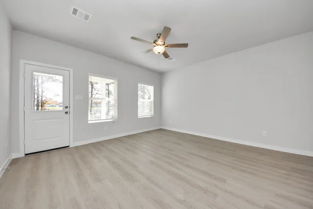 wooden floor in an empty room with a window