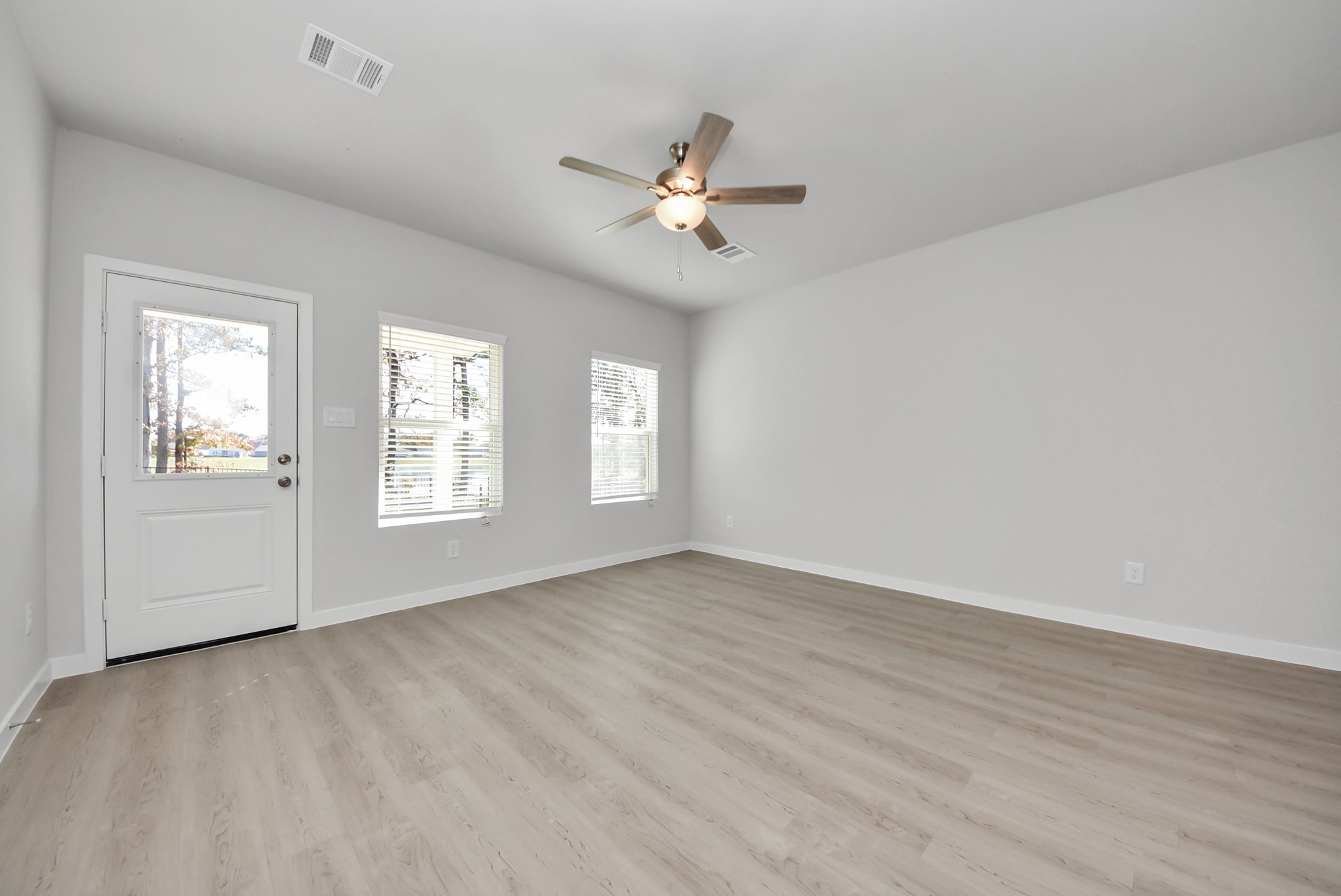 473 Shoreview Drive Conroe, TX 77303 - Photo 30 of 49 wooden floor in an empty room with a window