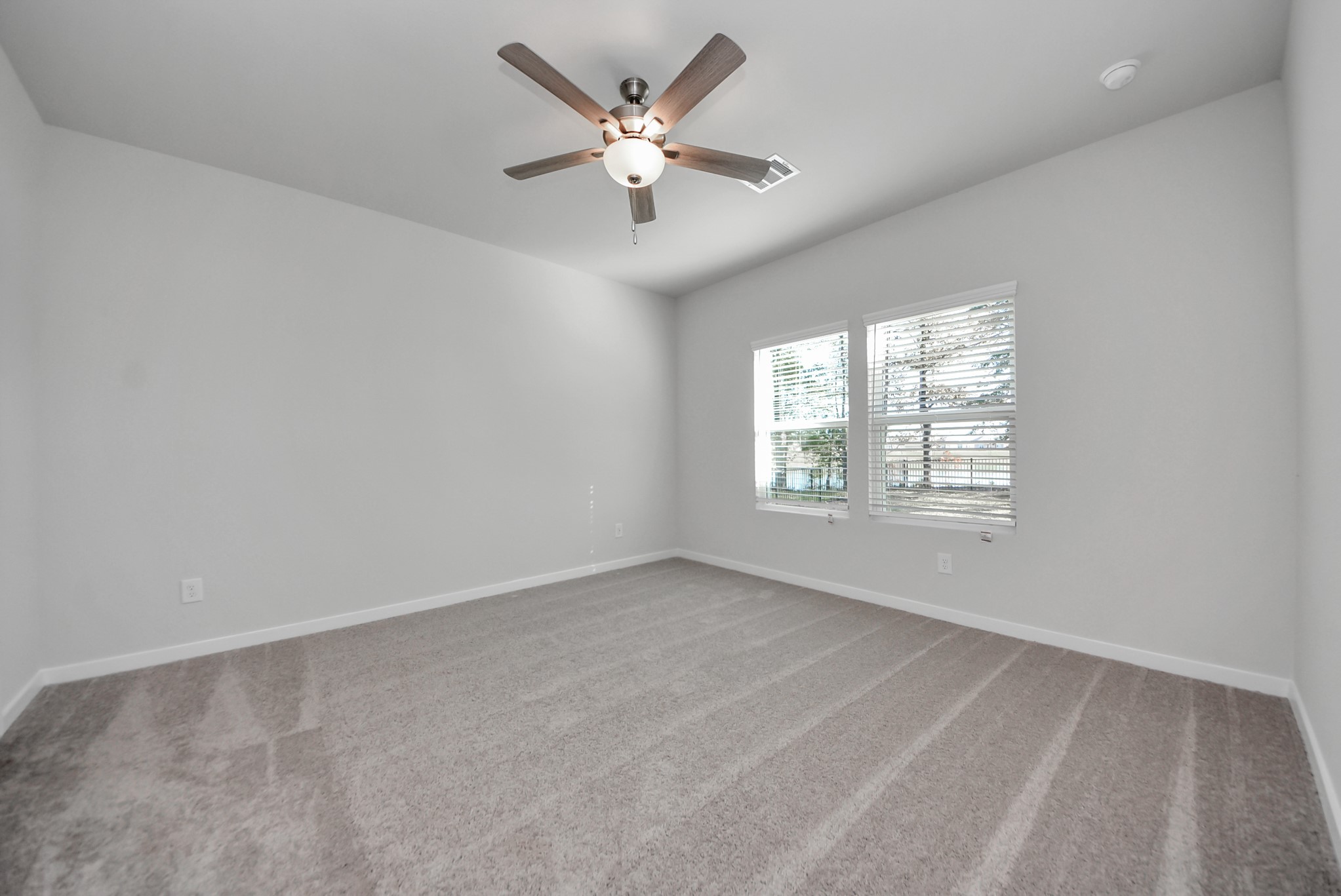 473 Shoreview Drive Conroe, TX 77303 - Photo 32 of 49 an empty room with windows and fan