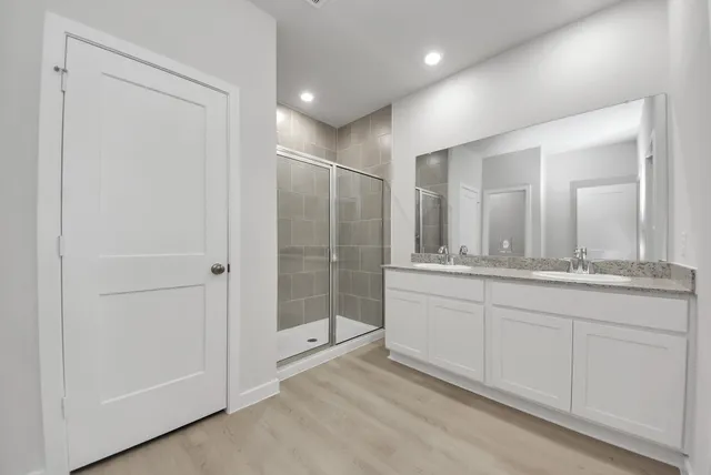 a bathroom with a shower and a sink