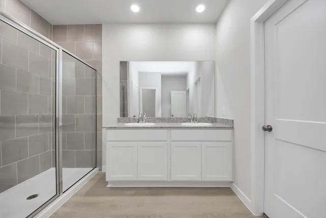 a bathroom with a mirror and a shower