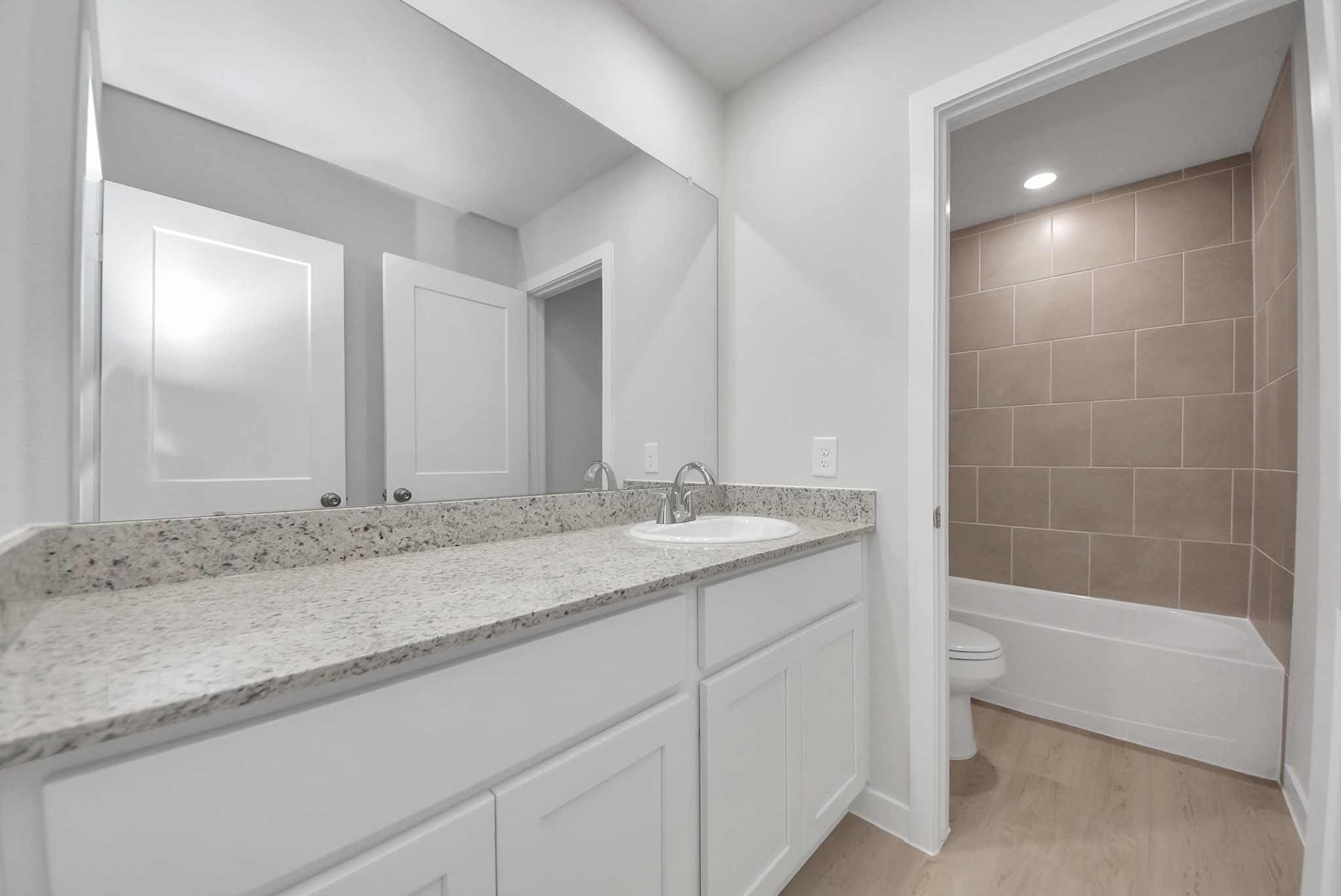 473 Shoreview Drive Conroe, TX 77303 - Photo 48 of 49 a bathroom with a granite countertop sink and a mirror