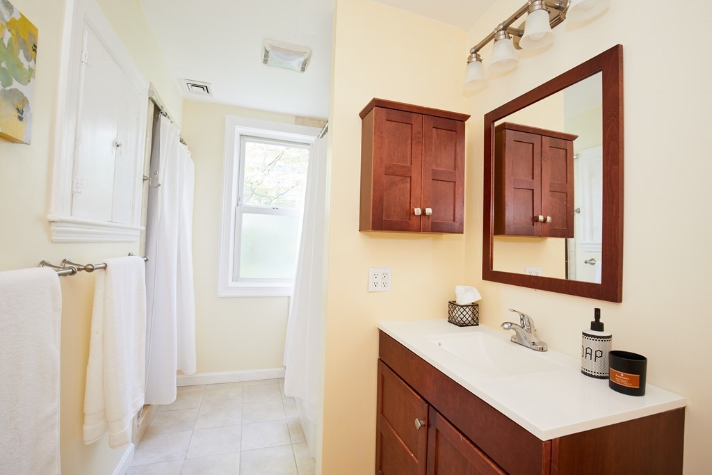 92 Coolidge Street, Unit 2 Brookline, MA 02446 - Photo 12 of 29 a bathroom with a sink vanity and mirror