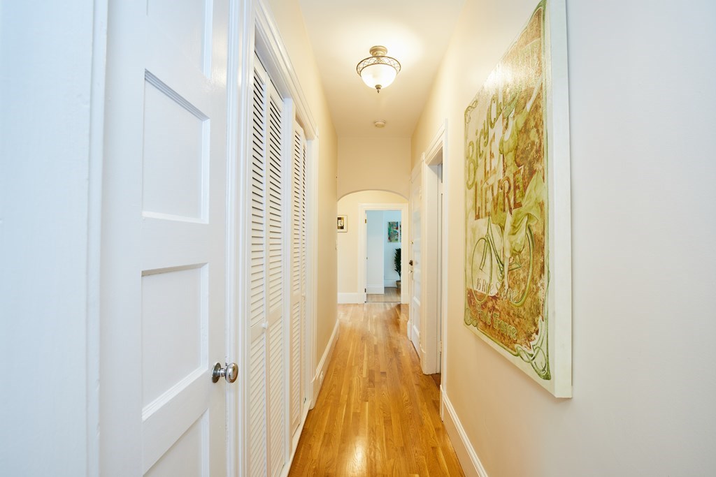 92 Coolidge Street, Unit 2 Brookline, MA 02446 - Photo 13 of 29 a view of a hallway with wooden floor and staircase
