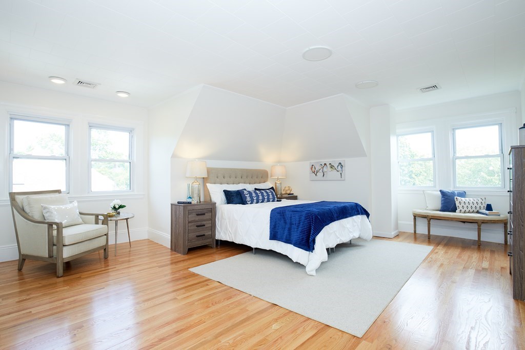 92 Coolidge Street, Unit 2 Brookline, MA 02446 - Photo 16 of 29 a bedroom with a large bed and a wooden floor