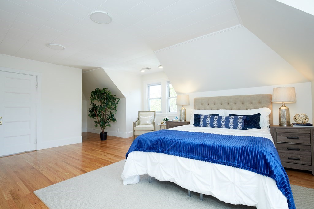 92 Coolidge Street, Unit 2 Brookline, MA 02446 - Photo 17 of 29 a bedroom with a large bed and a potted plant