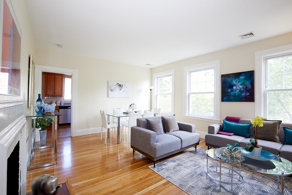 92 Coolidge Street, Unit 2 Brookline, MA 02446 - Photo 2 of 29 a living room with furniture wooden floor and a large window