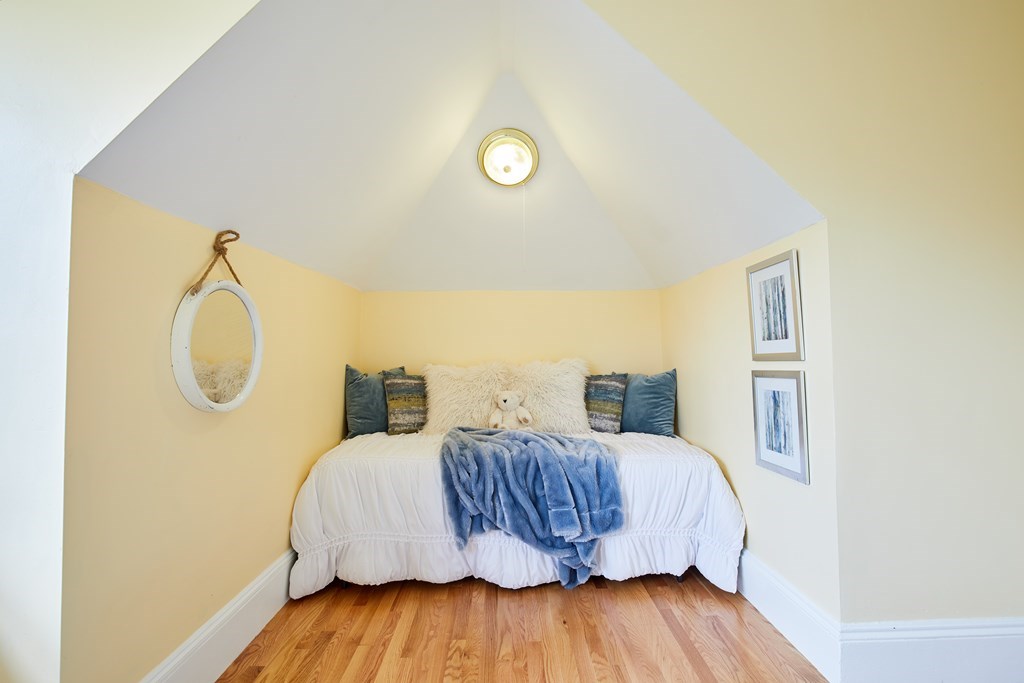 92 Coolidge Street, Unit 2 Brookline, MA 02446 - Photo 21 of 29 a bedroom with a bed and wooden floor