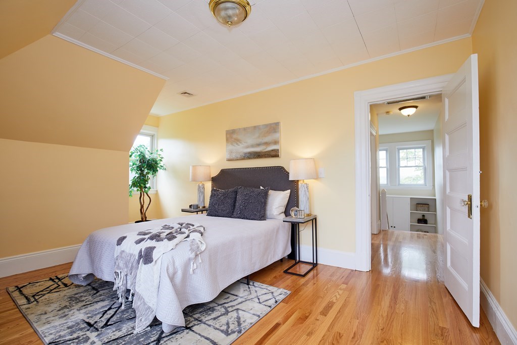 92 Coolidge Street, Unit 2 Brookline, MA 02446 - Photo 22 of 29 a bedroom with a bed and a potted plant