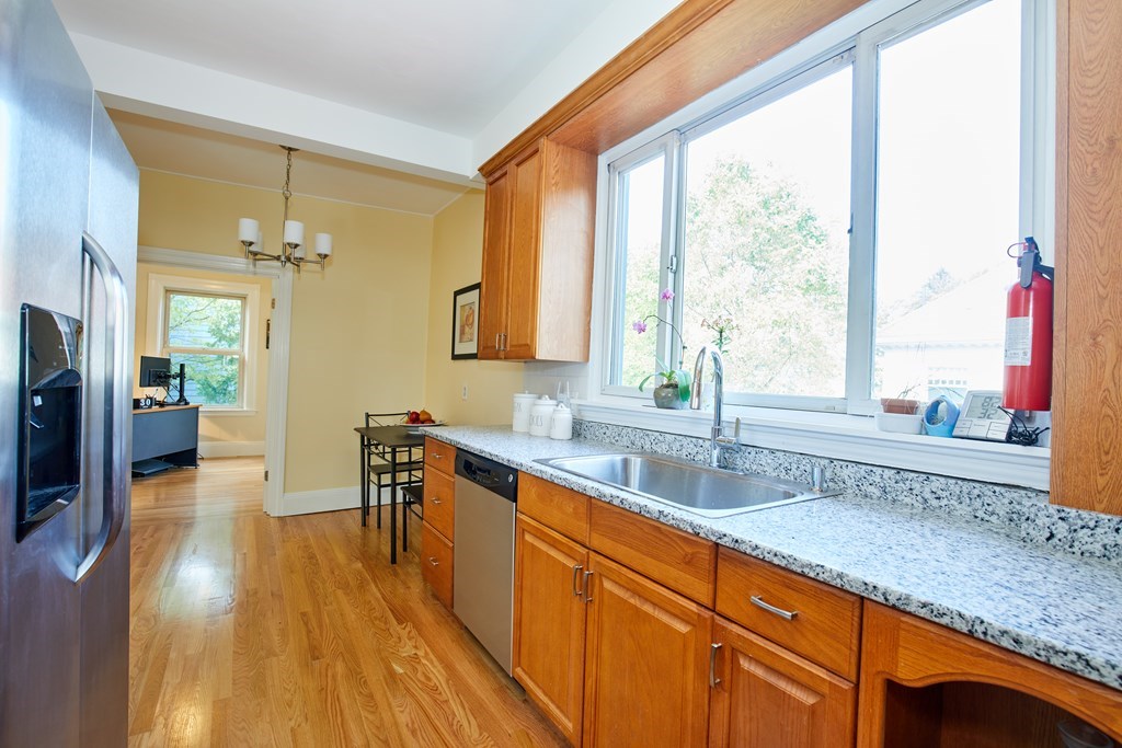 92 Coolidge Street, Unit 2 Brookline, MA 02446 - Photo 6 of 29 a kitchen with a sink a counter top space cabinets and stainless steel appliances