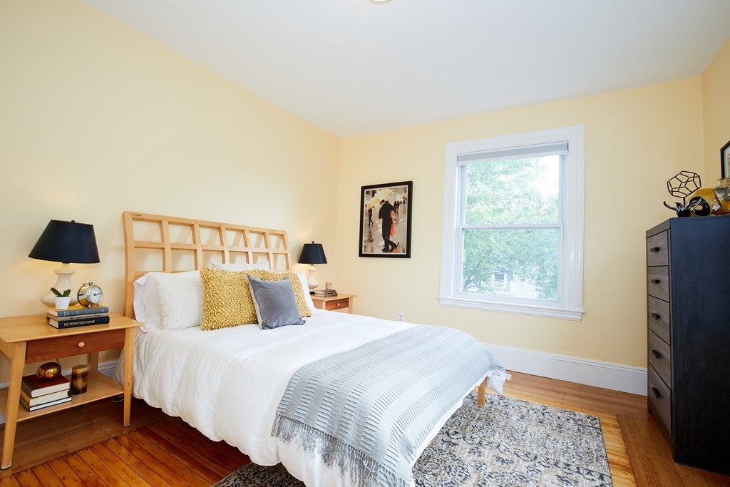 92 Coolidge Street, Unit 2 Brookline, MA 02446 - Photo 9 of 29 a bedroom with a bed and wooden floor