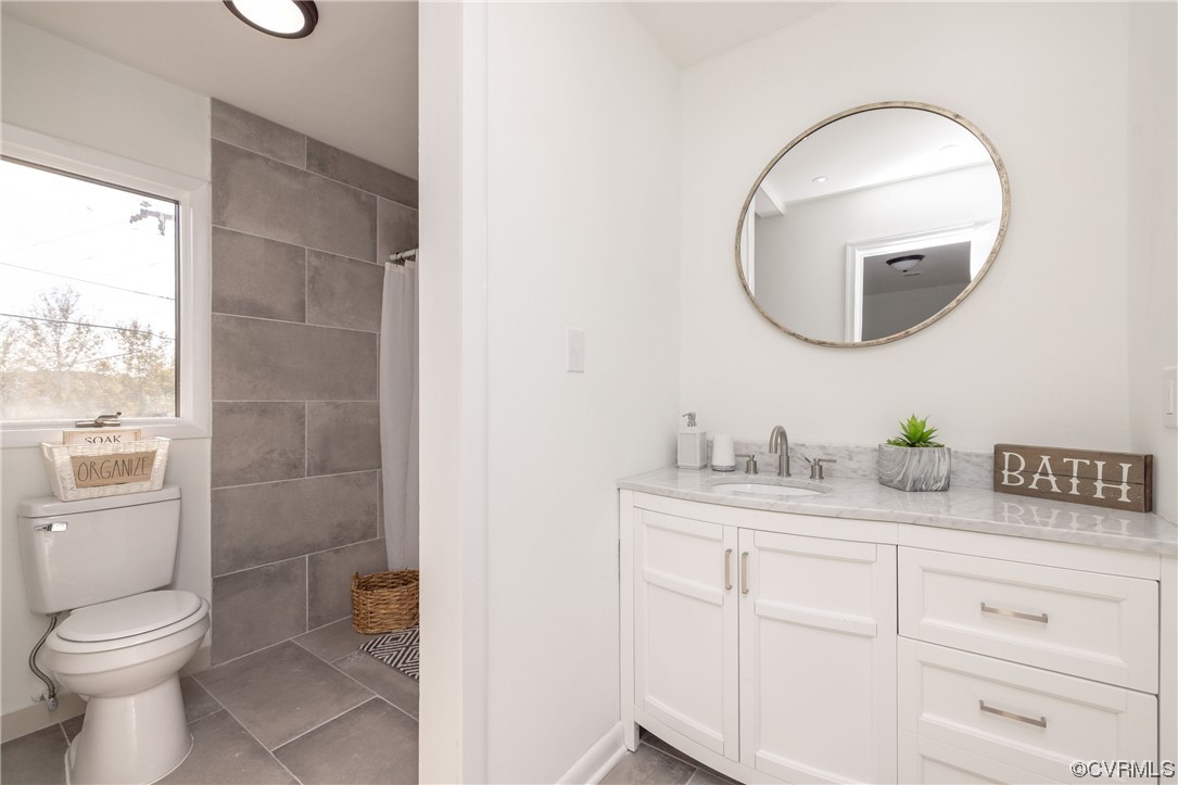 1701 Quail Covey Road Henrico, VA 23238 - Photo 25 of 45 a bathroom with a toilet a sink and mirror