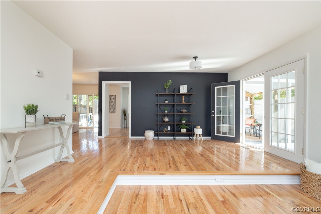 1701 Quail Covey Road Henrico, VA 23238 - Photo 6 of 45 a living room with a large window wooden floor and chandelier