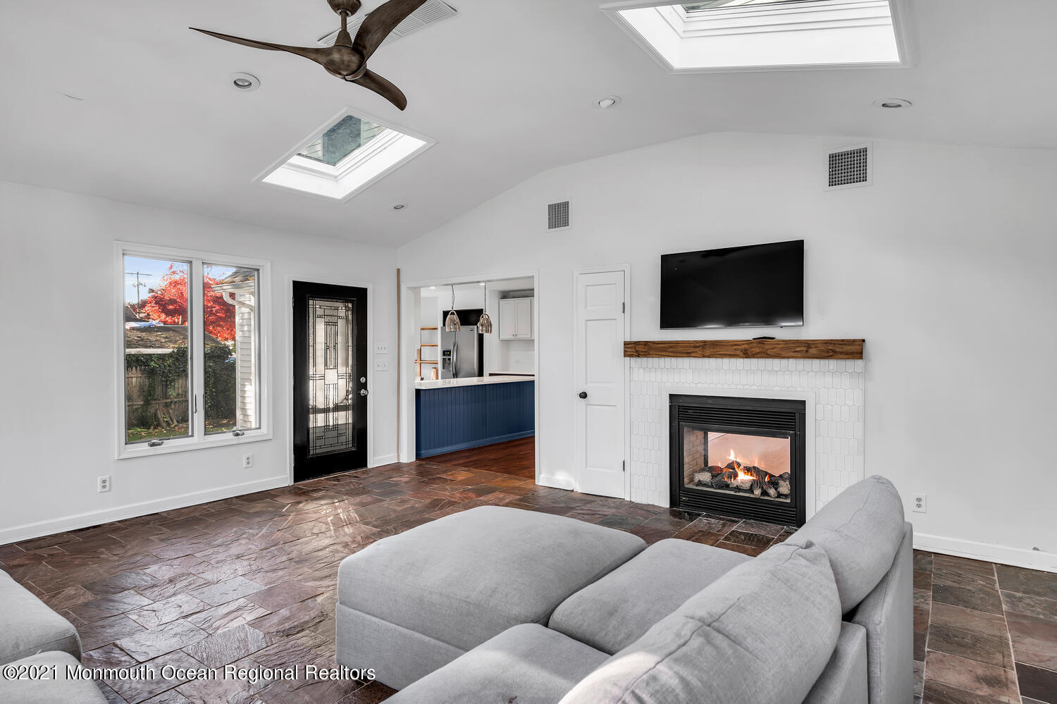 490 River Road Fair Haven, NJ 07704 - Photo 3 of 16 a living room with furniture a flat screen tv and a fireplace
