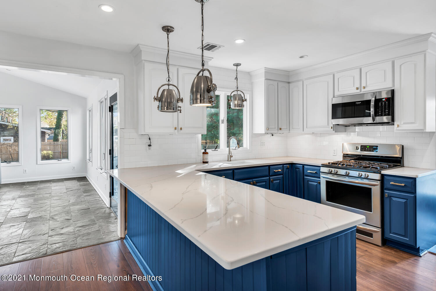 490 River Road Fair Haven, NJ 07704 - Photo 5 of 16 a kitchen with stainless steel appliances granite countertop a sink a stove a microwave a refrigerator a stove and white cabinets