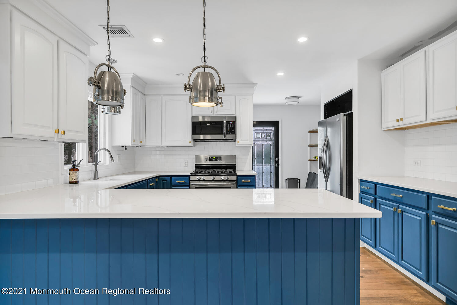 490 River Road Fair Haven, NJ 07704 - Photo 6 of 16 a large kitchen with stainless steel appliances a large counter top a stove and a sink