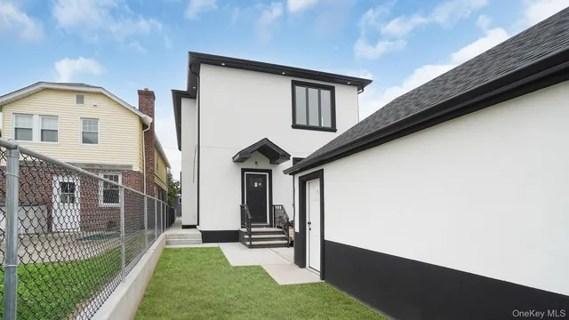 a view of house with backyard