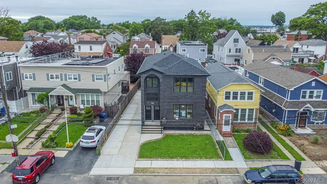 an aerial view of residential houses and car parked on street side