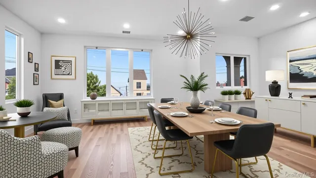 a living room with furniture kitchen view and a large window